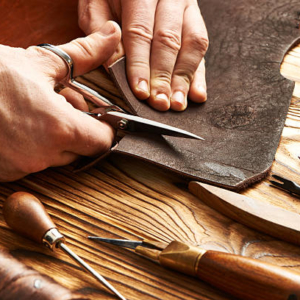Man working with leather using crafting DIY tools